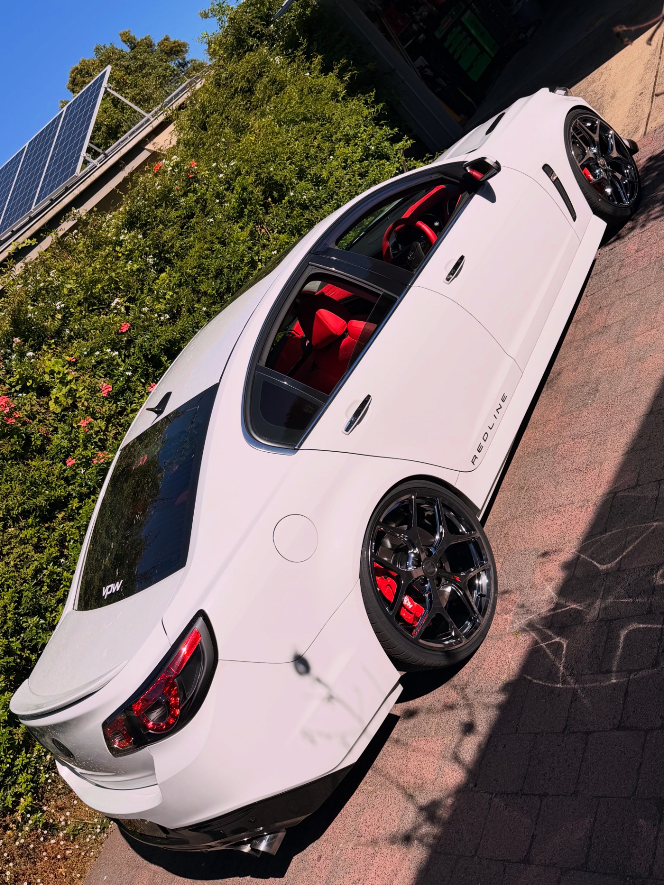 White Holden Commodore VF Redline with red interior on gloss black wheels